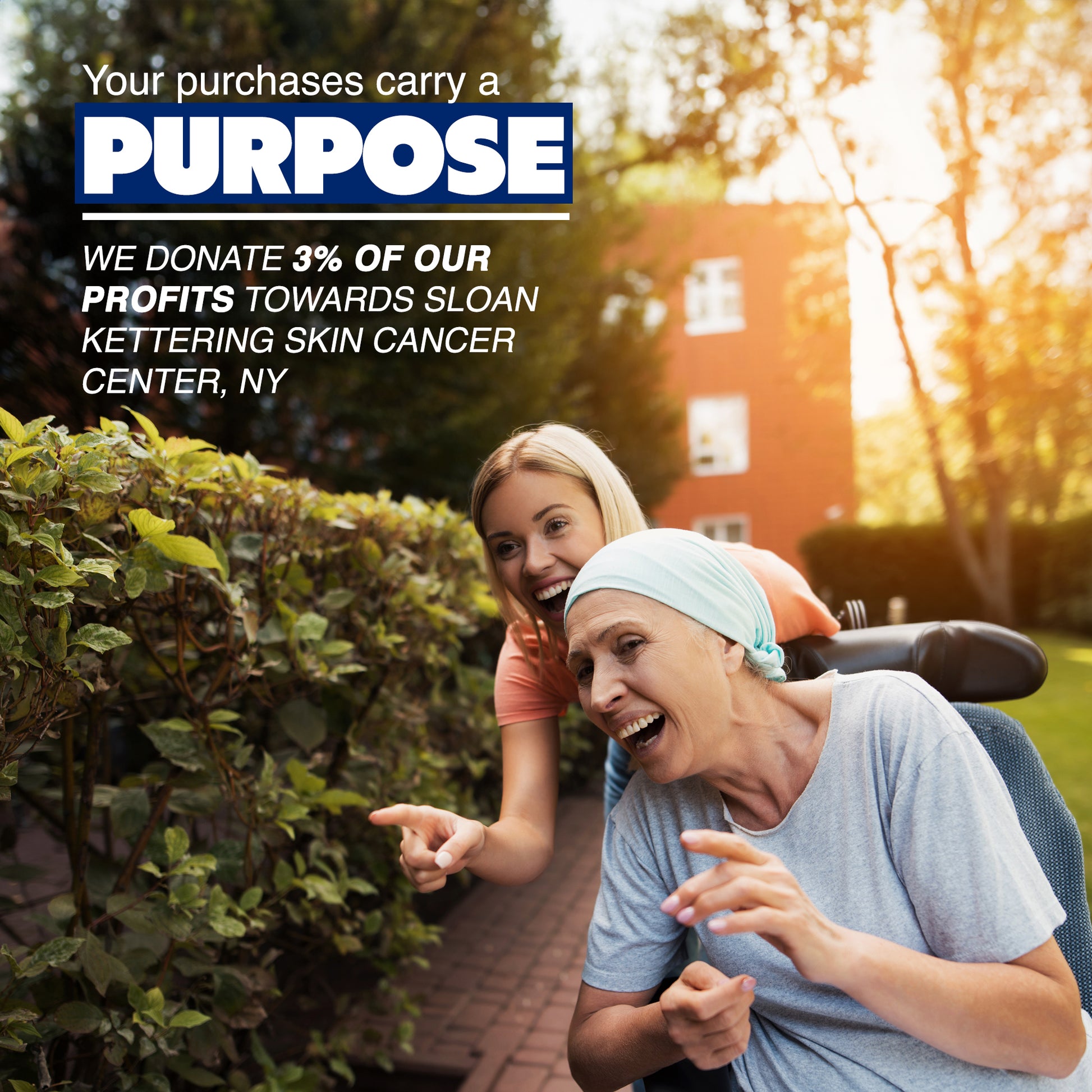 A smiling woman in a headscarf, wearing ARMORAY Basics Armoray® Arm Sleeves, sits in a wheelchair outdoors pushed by another woman. Enjoy cooling sun protection—3% of profits donated to Sloan Kettering Skin Cancer Center, NY.