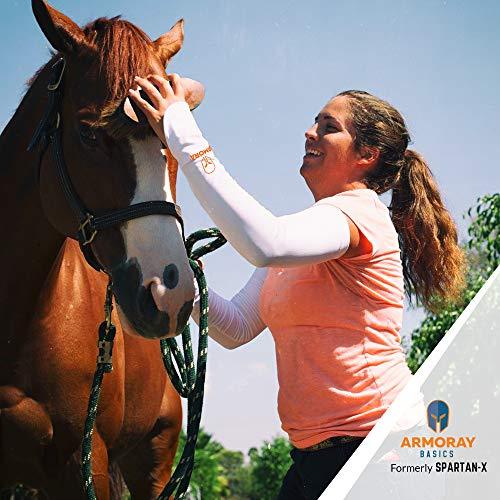 A woman in a pink shirt wears Armoray® Thumbhole Arm Sleeves by ARMORAY Basics while adjusting a brown horse’s bridle outdoors for total sun protection. The ARMORAY Basics logo is visible in the lower right corner.
