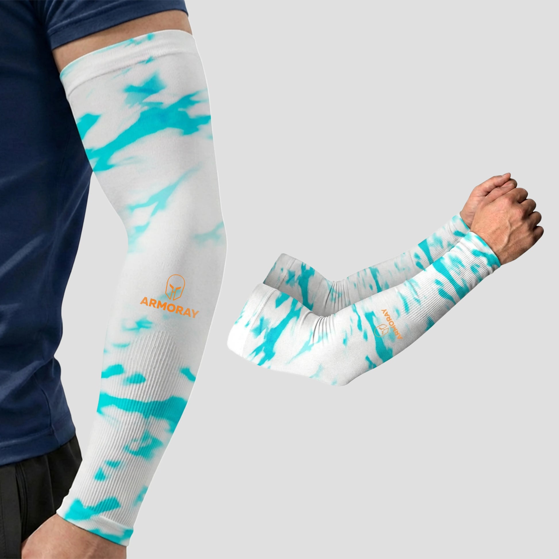 A person wears an ARMORAY Armoray® Patterned Arm Sleeve in a white and light blue camouflage design featuring the Armory logo, providing UPF 50+ sun protection; a second designer arm sleeve from the collection is displayed separately on a plain background.