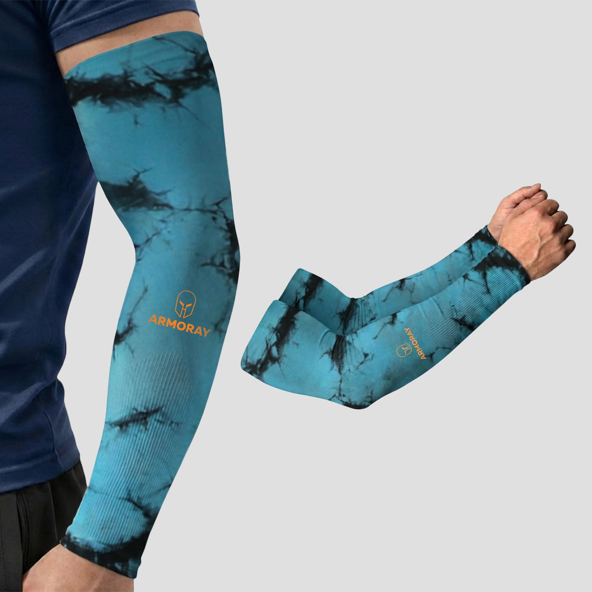 A person wearing the ARMORAY Armoray® Patterned Arm Sleeve in a blue and black tie-dye design, featuring the ARMORAY logo, is pictured next to a close-up of crossed arms showcasing the sleeve. Combining standout style with UPF 50+ sun protection, these sleeves are part of ARMORAY’s collection of 35+ bold looks.