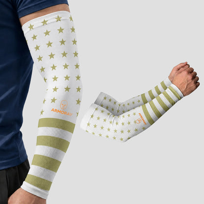 Wearing an ARMORAY Armoray® Patterned Arm Sleeve in a white design with olive green stars and stripes, this person enjoys both standout style and UPF 50+ sun protection, while a matching sleeve from ARMORAY’s collection of 35+ bold looks is displayed next to their arm.