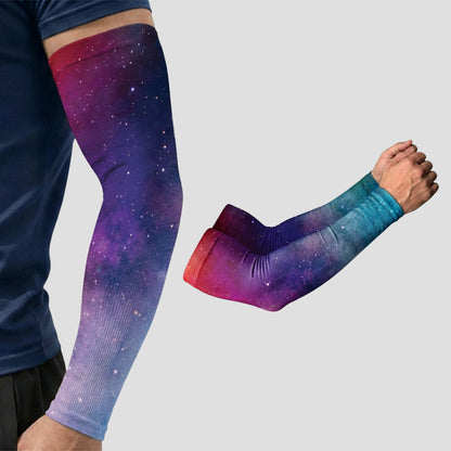 Wearing the ARMORAY Armoray® Patterned Arm Sleeve in a vibrant galaxy print—which delivers UPF 50+ sun protection—a person showcases this designer accessory, while a second sleeve from the same 35+ bold looks collection is displayed separately on a plain background.