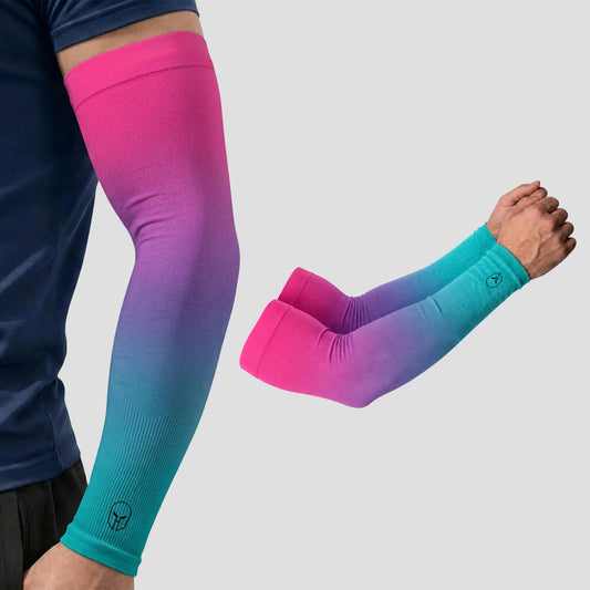 A person wearing ARMORAY Gradient Arm Sleeves, featuring a pink-to-turquoise gradient and a subtle logo near the wrist, combines stylish design with UV protection.