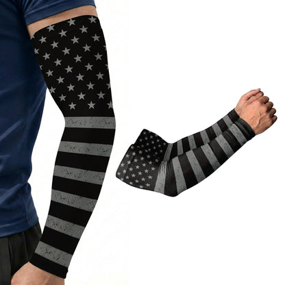 A person wears an Armoray® Designer Arm Sleeve by ARMORAY Basics in a black and gray American flag pattern with UPF 50+ protection; a close-up of the sleeve is shown beside it.