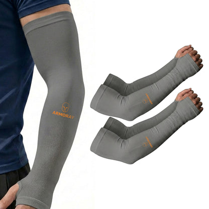 A person wears a gray Armoray® Thumbhole Arm Sleeve by ARMORAY Basics, featuring orange branding and extended hand coverage; a matching pair of sleeves is displayed next to the arm.