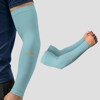 Wearing a light blue ARMORAY® Classic Arm Sleeve, a person stays cool and comfortable; nearby, a pair of these ARMORAY sleeves is displayed separately on a gray background, ready to provide protection.