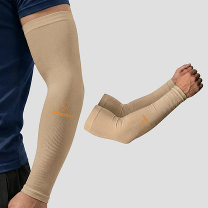 A man wears Armoray® Classic Arm Sleeves in beige, displaying the “ARMORAY” logo and exuding a cool, comfortable look; a separate image shows the sleeves alone on a plain grey background—emphasizing the sense of protection they provide.