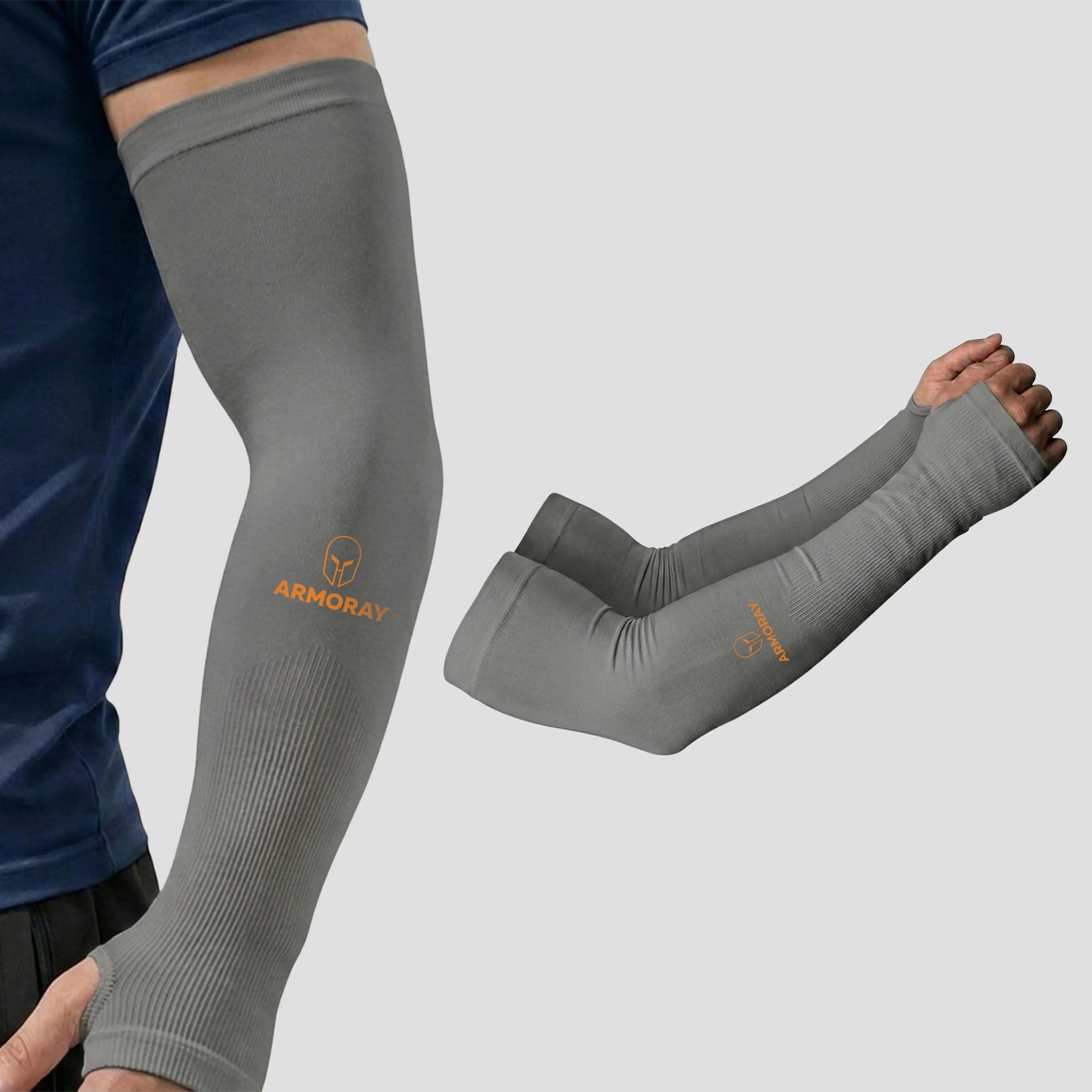 A person wearing Armoray® Thumbhole Arm Sleeves by ARMORAY—gray compression sleeves featuring the orange “ARMORAY” logo, providing sun protection and extended hand coverage with thumbholes—is shown next to a pair of sleeves displayed on a neutral background.