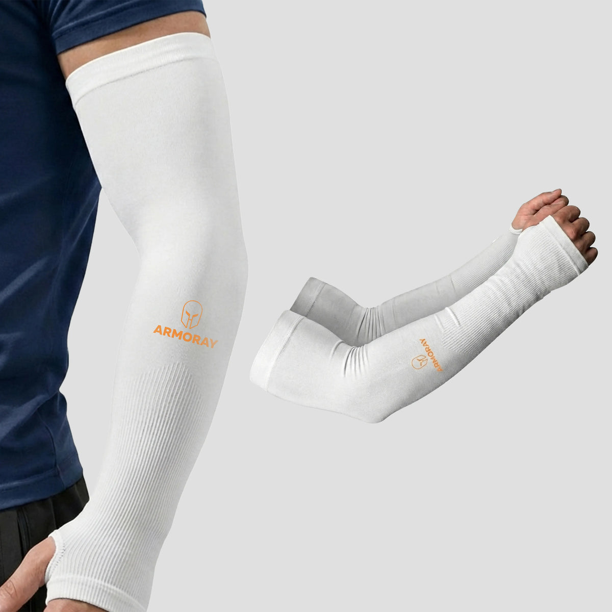 A person wears Armoray® Thumbhole Arm Sleeves by ARMORAY, featuring a white compression design with extended hand coverage and convenient thumbholes for added comfort. An extra pair of these sun protection sleeves is displayed beside the wearer on a plain background.