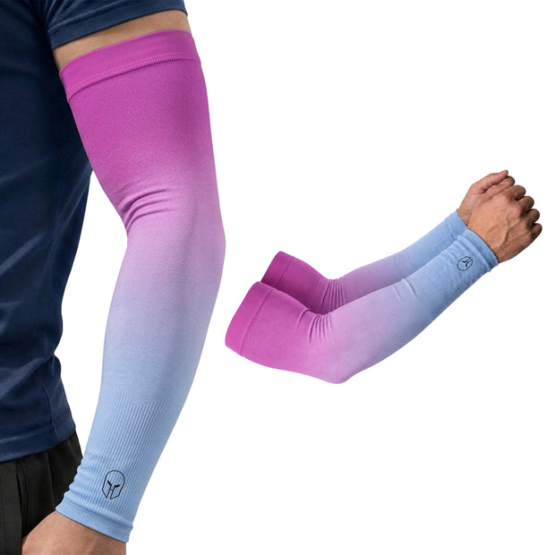 A person wears ARMORAY Gradient Arm Sleeves in pink and blue, showcasing these stylish UPF 50+ sleeves that provide excellent UV protection. The close-up highlights two gradient ARMORAY sleeves—one displaying a visible logo near the wrist—making them perfect for anyone seeking both fashion and functionality with no-slip performance.