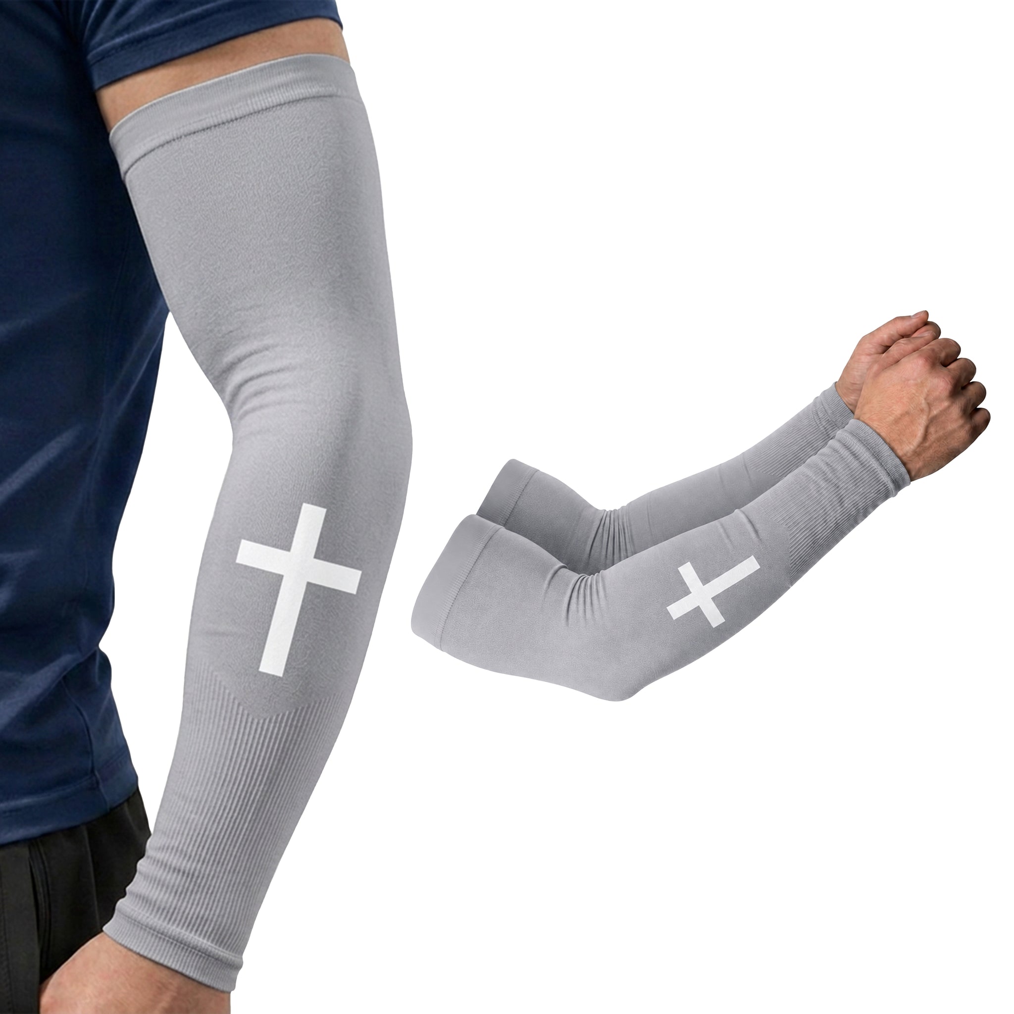 A person is wearing the ARMORAY Faith Series gray arm compression sleeve with a white cross, made from moisture-wicking fabric for all-day comfort, shown next to a matching pair of sleeves on a white background.