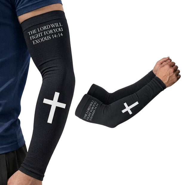 Wearing ARMORAY's Faith Series arm sleeves, a person sports black sleeves featuring a white cross and the words "THE LORD WILL FIGHT FOR YOU, EXODUS 14:14" printed near the upper arm. These scripture-inspired designs also provide UPF 50+ sun protection for extra comfort during outdoor activities.