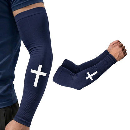 A person wearing ARMORAY Faith Series navy blue arm sleeves featuring a white cross design; these moisture-wicking sleeves display scripture designs and offer UPF 50+ sun protection. A matching pair of ARMORAY Faith Series sleeves with the same cross motif is also shown.