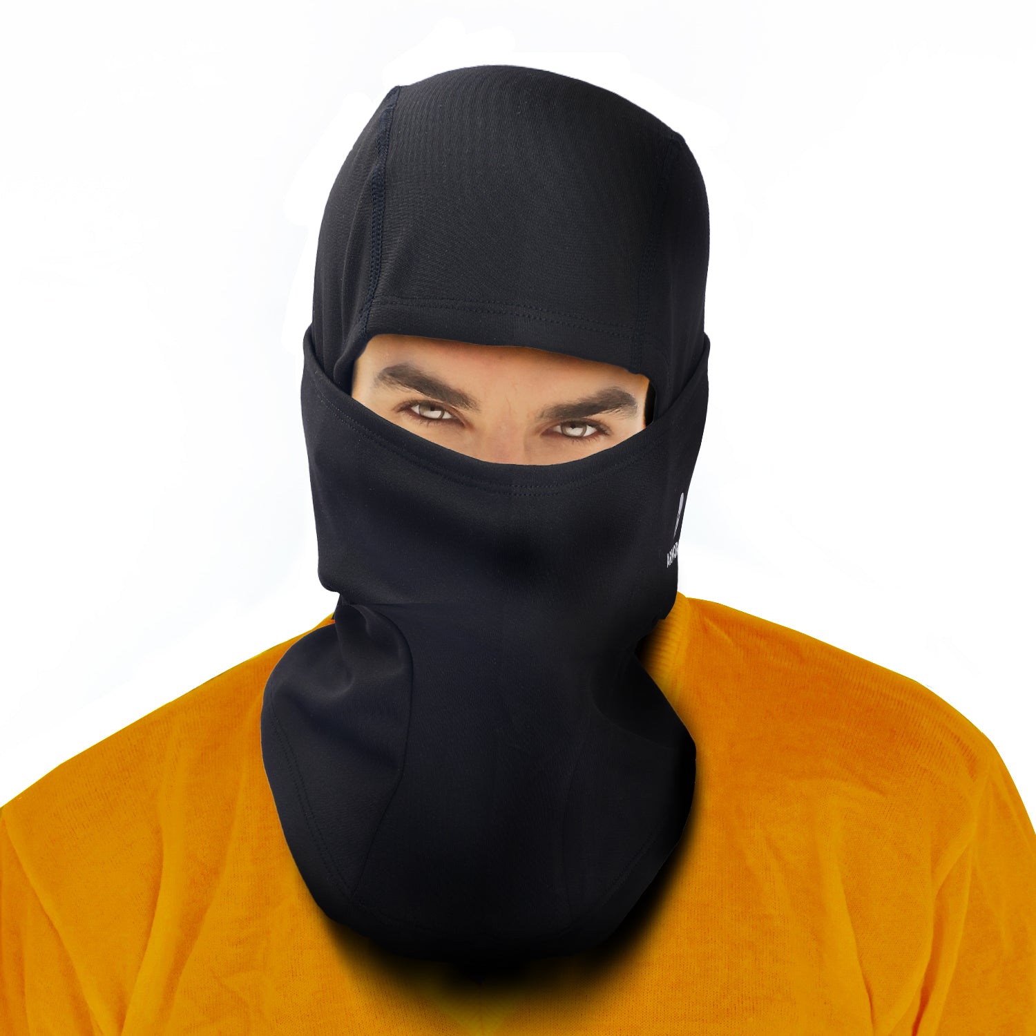 A person wears the ARMORAY Basics BALACLAVA in black, paired with an orange shirt. Only their eyes and part of their forehead are visible against a white backdrop—perfect for winter face protection.