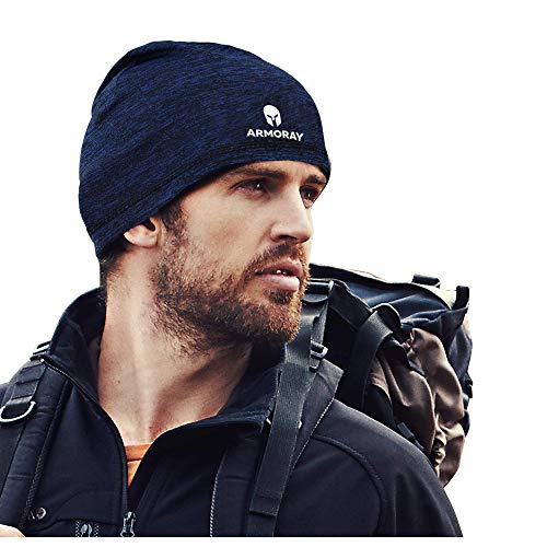 A bearded man wearing a dark, sweat-wicking Armoray Skull Cap Running Hat Beanie by ARMORAY Basics and a backpack looks to the side, with the "ARMORAY" logo visible on his beanie.