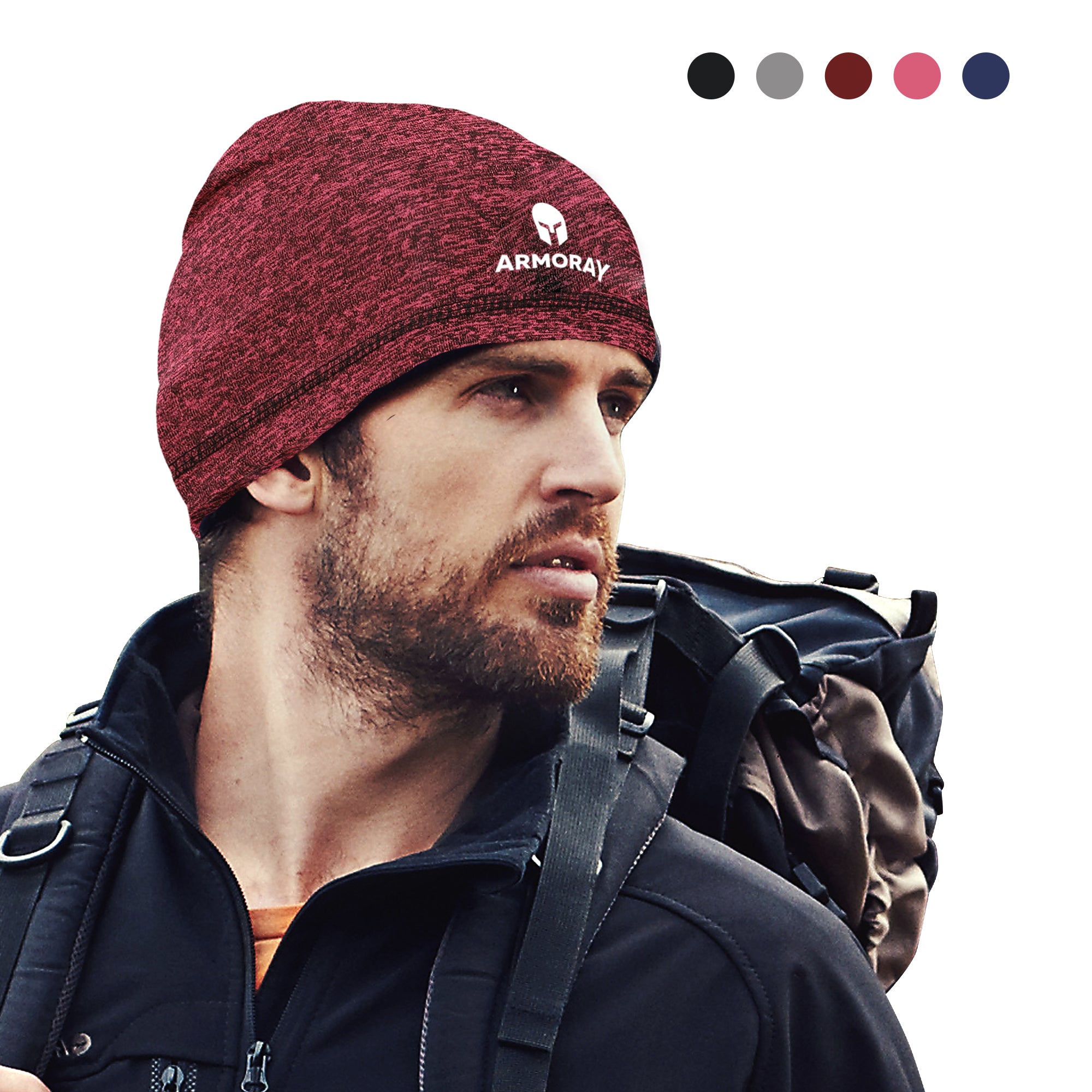 A bearded man wears the Armoray® Performance Skull Cap by ARMORAY Basics as a helmet liner with a black jacket and backpack. Five color swatches appear in the top right, showcasing cold-weather options.