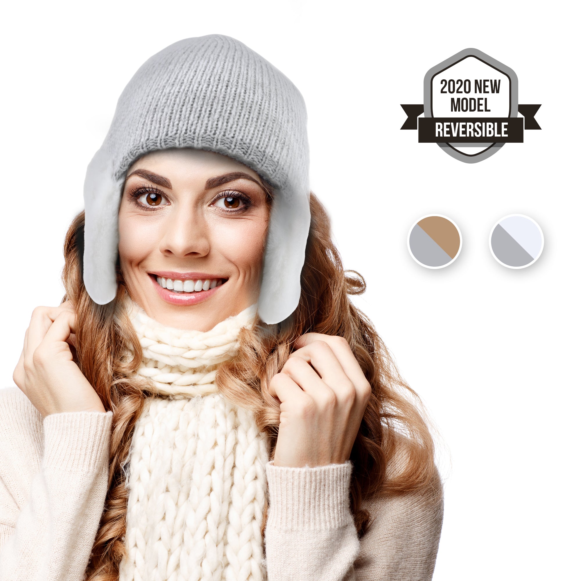 A woman models the ARMORAY Basics Winter Beanie with Earmuffs, a reversible gray knit hat for cold weather, styled with ear flaps like earmuffs and paired with a chunky cream scarf. "2020 New Model Reversible" badge and color options shown.